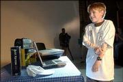 Tracy Bowersox, 13, Tonganoxie, admires his new computer after
receiving it and digital video software as a gift from the
Children's Wish Foundation. Tracy, who has cystic fibrosis, dreams
of a career in filmmaking. The gift was presented to him Friday at
Oldfather Studios by students in the Kansas University theater and
film department.