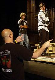 Nationally noted fight choreographer D.C. Wright gives direction to
actors during rehearsal for the upcoming University Theatre
production of "Romeo and Juliet." Wright worked with the KU cast
several weekends to finalize the play's fight sequences.