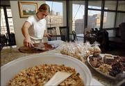 Sarah Levy, 23, spreads dark chocolate out on a granite countertop
for a candy she calls Dark Chocolate Delight in her parents'
kitchen in Chicago. Levy, a former restaurant pastry chef, started
her own business, "Sarah's Pastries & Candies Inc." at her
parents' home in March and started turning a profit last month.