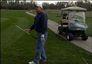 Keith Rasmussen, of Lawrence, watches his golf ball fly to the
green at Eagle Bend Golf Course. Rasmussen squeezed in as many
holes as he could Wednesday before the rain started.