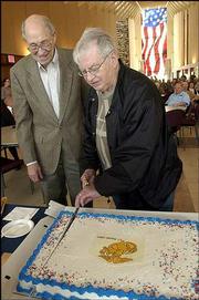 Marvin Metzger, 82, left, and Dale Kearney, 83, both of Lawrence,
cut birthday cake in recognition of being the oldest U.S. Marine
Corps members in attendance at the 14th annual Lawrence Marine
Corps birthday celebration. Wednesday's ceremony at the Dole
Institute of Politics celebrated the 229th anniversary of the U.S.
Marine Corps.