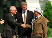 President Clinton presides over White House ceremonies marking the
signing of the peace accord between Israel and the Palestinians,
with Israeli Prime Minister Yitzhak Rabin, left, and PLO chairman
Yasser Arafat, on Sept.13, 1993. Arafat, Rabin and Israeli Foreign
Minister Shimon Peres were awarded the Nobel Peace Prize in 1994.