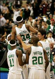 Boston's Paul Pierce is lifted by teammates, from left, Walter
McCarty, Marcus Banks, Gary Payton and Raef LaFrentz after hitting
the game-winning shot at the buzzer. The Celtics defeated the Trail
Blazers, 90-88, Wednesday night in Boston.