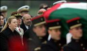 Suha Arafat, left, watches the casket of her husband, former
Palestinian leader Yasser Arafat, as it is carried by a French
military honor guard at Villacoblay airbase southwest of Paris.
Arafat died early Thursday at a Paris hospital.