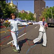 Julie Goodridge, left, and her spouse, Hillary Goodridge, cross the
street after being married May 17. The Goodridges were the lead
plaintiffs in the Massachusetts gay marriage lawsuit. Supporters
will celebrate the first anniversary of the landmark Massachusetts
ruling Nov. 18.