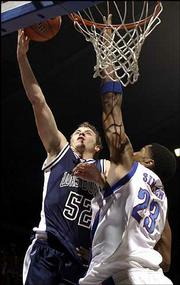 Washburn's Kyle Snyder (52), a native of Effingham and longtime KU
fan, goes up for two over Kansas preseason All-American Wayne
Simien. Snyder finished with four points Sunday at Allen
Fieldhouse.