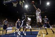 Kansas' Aaron Miles gets airborne against Washburn. Miles finished
with 10 points and five assists against the Ichabods.