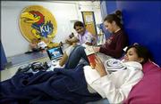 Kansas University freshmen Liz Mukherjee, foreground, from Overland
Park, Kristen Wehkamp, center, Garden City, and Liz's twin sister,
Katie Mukherjee, camp for seats at tonight's KU-Vermont basketball
game in sleeping bags outside the men's locker room. The group has
been in line at Allen Fieldhouse since 6 a.m. Monday.