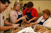 Volunteers from left, Eric Ackers, Sarah Harper, William Miller and
Kim Collie clean meat off turkeys cooked at St. John the Evangelist
Church in preparation for last year's Lawrence Interdenominational
Nutrition Kitchen Thanksgiving dinner.