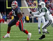Buffalo running back Willis McGahee (21) eludes New York Jets
defender David Barrett. McGahee, shown Nov. 7 in Orchard Park,
N.Y., will return to his hometown Sunday for a game against the
Miami Dolphins.