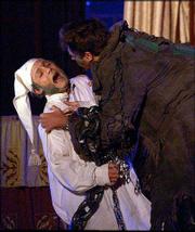 JACOB MARLEY, RIGHT, played by actor Jeff Conaway, of "Grease" and
"Taxi," holds Ebenezer Scrooge, played by Greg Younger, during a
rehearsal of Charles Dickens&squot; "A Christmas Carol" in Albany, N.Y.
The traveling production is among a number of duplicates of the
popular Christmas story available this season.