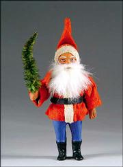 This papier-mâche santa has a rabbit-fur beard and blue, painted
trousers, both added-value features. The 7-inch figure sold at an
auction for $240.