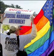 A supporter of the Federal Marriage Amendment is blocked by a gay
American flag from a protester before a march from the Sts. Paul
and Peter Church through North Beach in San Francisco in this April
3, 2004, file photo. Though gay-marriage opponents made headway in
the November elections, a constitutional ban on the issue will face
many obstacles in Washington.