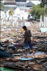 Debris from destroyed buildings and dozens of bloated bodies litter
the streets of Banda Aceh, Indonesia. Soldiers and volunteers
searched Monday for survivors of the earthquake and tidal waves
that killed thousands in Indonesia.