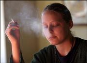 Nicole Carr, Lawrence, smokes over coffee at the Bourgeois Pig
before the city banned smoking in indoor public places.