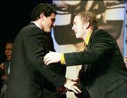 USC quarterback Matt Leinart, left, is congratulated by Oklahoma
quarterback Jason White after Leinart won the Heisman Trophy. The
two attended the Heisman Trophy banquet Dec. 11 and will face each
other in tonight's Orange Bowl in Miami