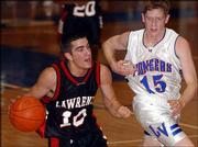 Lawrence High&squot;s Brennan Bechard drives against James Manthe (15).
Bechard scored 16 in the Lions&squot; 67-61 victory Friday at
Leavenworth.<br>
<a href=
"http://etc.lawrence.com/galleries/Boys-Lawrenc/6915_lores.html"
target="_new" onclick=
"window.open(&squot;http://etc.lawrence.com/galleries/Boys-Lawrenc/6915_lores.html&squot;,&squot;Photo&squot;,&squot;height=650,width=550,screenX=10,screenY=10,&squot; + &squot;scrollbars,resizable&squot;); return false;">
<img src="http://www.ljworld.com/art/icons/icon_photo.gif" border=
"0" alt="photo"> Photo Gallery: Boys - Lawrence High vs.
Leavenworth (01-07-05)</a><br>