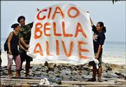 Isari Chanswan, left, her boyfriend, Umberto Giovi, 42, from Rio
Elba, Italy, center, and Anucha Jangho, a restaurant staffer, hold
a banner they made to signal rescue flights after the tsunami
destroyed their restaurant on the island of Phi Phi, Thailand.
Giovi and the staff of Ciao Bella restaurant fled to the hills for
12 days before returning to the beach Friday to find what was left
of their restaurant.