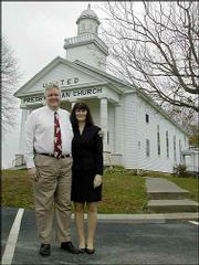 The Rev. Chris Perkins and his wife, Bunny, stand outside the
church where he is pastor in Ezel, Ky. Perkins, a former
congressman, served 21 months in prison for his part in a banking
scandal in the early 1990s.