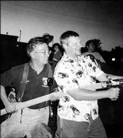Joe Mehl, of Lawrence Fire Station No. 2, helps Brian Walter,
Knights of Columbus Council 1372 family activity director, man the
fire hose. The club had a family night Sept. 24 and learned about
fire safety.