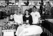 Kansas University students, from left, Jessica Vega, Erin Hogan and
Nick Wright help raise funds for the Boys and Girls Club of
Lawrence at Dillons, 1015 W. 23rd St. The students are members of
Beta Alpha Psi, an honorary accounting fraternity. They worked Oct.
30 on Roundup Day, when club representatives ask Dillons customers
if they would like to round up the total of their purchases to
benefit the nonprofit organization.