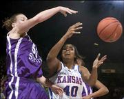 Kansas University forward Crystal Kemp (40) fights for a loose ball
with Kansas State's Kendra Wecker during the second half. Kemp was
held to 10 points, and the Wildcats beat the Jayhawks, 63-45,
Saturday at Allen Fieldhouse.