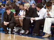 Kansas University coach Bonnie Henrickson, left, chats with
assistant coaches, from left, Katie O'Connor, Karen Lange and Kyra
Elzy during the second half against Kansas State. The Jayhawks
lost, 63-45, Saturday night at Allen Fieldhouse.