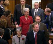 Gov. Kathleen Sebelius greets members of the Legislature during
opening day. Among those present Monday were Sen. Marci Francisco,
D-Lawrence, front, and Rep. Tom Sloan, R-Lawrence, right.