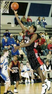 Lawrence High's Tony Anderson puts in a shot against Olathe
Northwest during the first half. The Lions won, 50-43, Friday night
in Olathe.