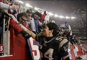 New England linebacker Tedy Bruschi celebrates with fans after
their 20-3 victory over the Indianapolis Colts in a AFC divisional
playoff game. Bruschi recovered two fumbles in the game Sunday in
Foxboro, Mass.