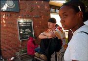 Nelle Johnson, Lawrence, passes time with acquaintances after lunch
outside The Salvation Army, 946 N.H.