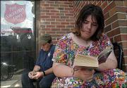 Robert Taylor, left, and Natasha Hulme sit outside the Salvation
Army waiting for the overnight shelter to open.