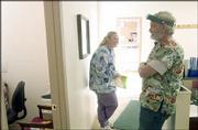 Dental assistant Michelle Sparks, McLouth, left, and Paul Heath,
the only dentist in McLouth, enjoy a moment between appointments
Thursday at the clinic.