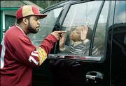 Former rapper Ice Cube, left, scolds Philip Daniel Bolden in the
family road comedy, "Are We There Yet?"