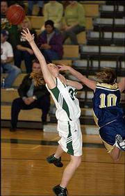 Free State High's Tricia Dunham shoots against Topeka Hayden's
Morgan Gaffney. The Firebirds won, 52-32, Thursday night at Free
State.