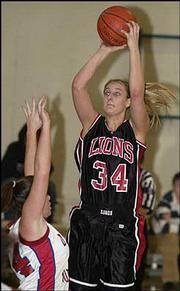 Lawrence High's Megan Klingler (34) shoots over Olathe North's Kim
Maguire. Klingler scored 12 points in the Lions' 45-24 victory
Friday night at the Firebird Winter Classic at Free State High.