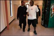 Kansas City (Kan.) Washington High's Darrell Stuckey, left, and his
best friend, Grady Henderson, share a laugh in the hallway as they
head for the weight room. Stuckey will be among the high school
football players who sign letters of intent today with Kansas
University.