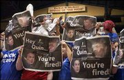 Kansas University fans hoist newspapers denouncing Missouri
basketball coach Quin Snyder. The ad appeared in the University
Daily Kansan and was purchased by Doug Compton, a longtime friend
of Snyder's. Compton is angry about the ad content.