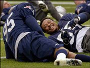 New England linebacker Willie McGinest, right, laughs with teammate
Roman Phifer during practice. The Patriots worked out Monday in
Jacksonville, Fla.
