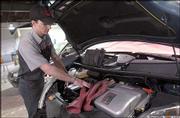 The Toyota Prius hybrid vehicle contains numerous high-voltage
circuits that are capable of producing more than 288 volts. If
mechanical repairs are needed or if the high-voltage battery needs
to be removed, Toyota recommends having a master technician perform
the service. Josh Baldwin, Prius certified automotive service
technician, looks under the hood of a Prius at Crown Toyota.
Certain areas of the Prius require the use of rubber gloves by
technicians when working around some of the electrical parts of the
vehicle.