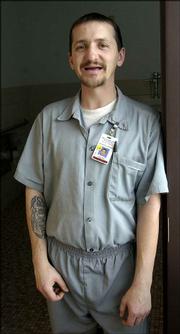 Inmate Jeffery Lotshaw shows his toothless mouth at the Maryville
(Mo.) Treatment Center. Lotshaw lost his teeth as a result of
methamphetamine use and is waiting for dentures. "It reminds me of
my addiction," he says.
