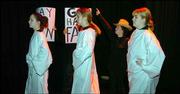 Thora Whitmore, back right, plays Fred Phelps in the Lawrence High
School play "The Laramie Project," which will be performed today
and Thursday. Whitmore works through her lines as other LHS
students portraying angels, from left, Vicki Bentley, Laura
Parkinson and Becca Bost, enter a scene during Monday's practice.