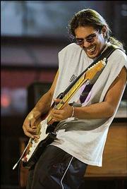 Los Lonely Boys guitarist Henry Garza performs during a rehearsal
before the Latin Grammy Awards in Los Angeles.