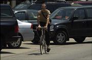 It can be a tough road to pedal when bicyclists have to ride in
traffic. Environmentalists such as Boog Highberger on the Lawrence
City Commission are pushing to ensure that newly developing areas
of town are friendly to pedestrians and bicyclists so residents can
walk or ride instead of drive.