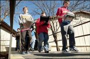 Book-toting students at South Junior High School head to their next
class during passing period. Though the U.S. Department of
Education has mandated that 100 percent of third- through
eighth-graders be proficient in math and reading by 2014, some
educators warn that such a goal is unrealistic.