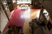 Pieces of an old basketball court from Allen Fieldhouse make up the
first floor of a rural Douglas County home, which is now for sale.