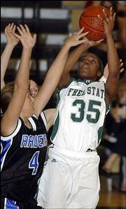 Free State's Banaka Okwuone (35) shoots over Olathe Northwest's
Lindsay Santee. The Firebird girls beat the Ravens, 45-31.