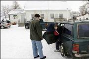 Eli Linquist is dropped off at school by his mother, Ruth Chantry,
at the two-room, K-8 Oak Valley School north of Lincoln, Neb. A
proposal to force elementary-only districts to merge with larger
kindergarten-through-12th-grade systems, which is being debated in
the Legislature, would force the closure of Oak Valley School.