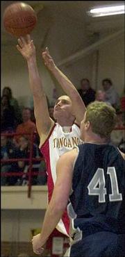 Tonganoxie's Sam Mitchell makes his shot against Mill Valley's Kyle
DeBerg. The Jaguars pounded the Chieftains, 71-40, Friday night in
Tonganoxie.