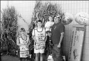 From left are Jessica Nau, Jennifer Anderson and Christopher Nau
being held by his father, Tom Nau. They participated in the Knights
of Columbus Council 1372 Tootsie Roll Drive Oct. 8-10 at Westlake
Hardware.